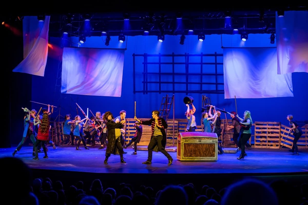 Students in a staged sword battle on deck for Peter and the Starcatcher