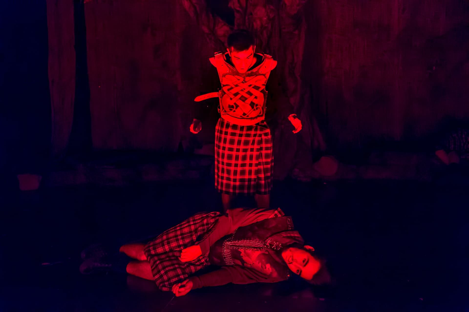 A dramatic red-lit death scene from Macbeth